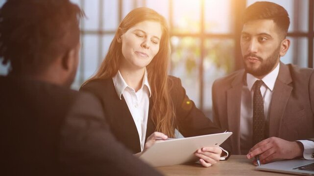 sitting at the table. Young business people working in the office
