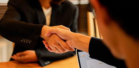 close up businesswoman handshake with vendor after the completed acquisition or project and collaboration of two ceo executive for make agreement or deal financial cooperative concept