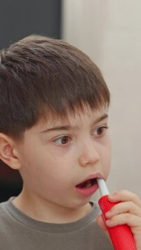 boy and baby child in bathroom,brushing teeth,washing hands with soap,combing hair.siblings,brothers in front of sink on tabouret chair.kids on toilet with lot of paper.