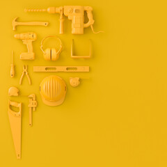 Top view of monochrome construction tools for repair on multicolor background