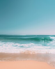Obraz premium Serene beach scene with clear turquoise water, gentle waves, and sandy shore under a bright blue sky