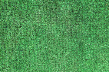 Green artificial grass. Green coating from above, texture, background.  Decorative grass for...