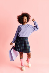 A fashionable African American woman with curly hair holds shopping bags in a purple sweater and plaid skirt.