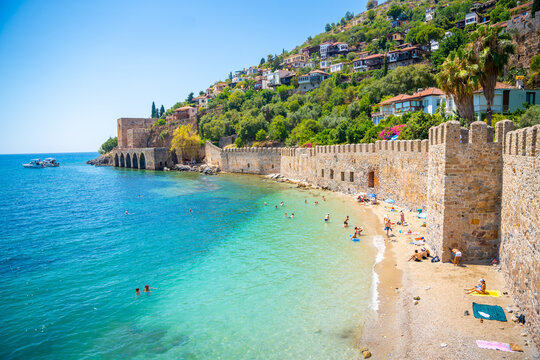 Ancient shipyard or Tersane near of Kizil Kule tower and beautiful beach and calm turquoise sea surface in Alanya, Turkey
