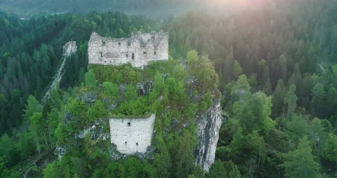 Aerial view of Castel belfort in Dolomite Alps, Italy. Old historical tourist fortress in the natural landscape of mountain peaks and ridges, pine forest. High quality 4k footage