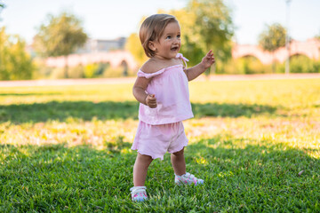 Cute Toddler Girl Standing In The Park