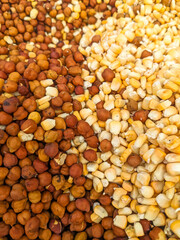 pile of black chickpeas and corn seeds mix, close up food background