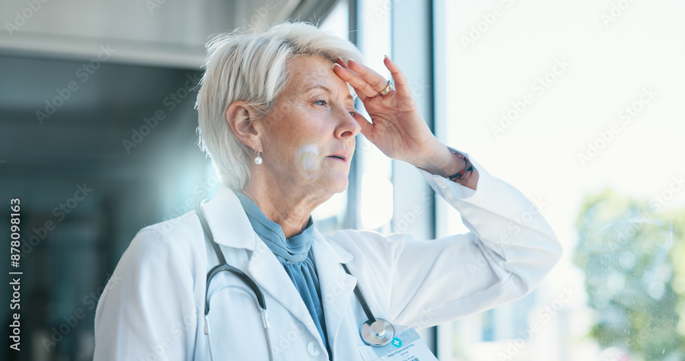 Canvas Prints Mature woman, doctor and headache in grief, burnout or mistake against glass window in hospital building. Frustrated physician, medical healthcare and person in stress, loss or fatigue at clinic