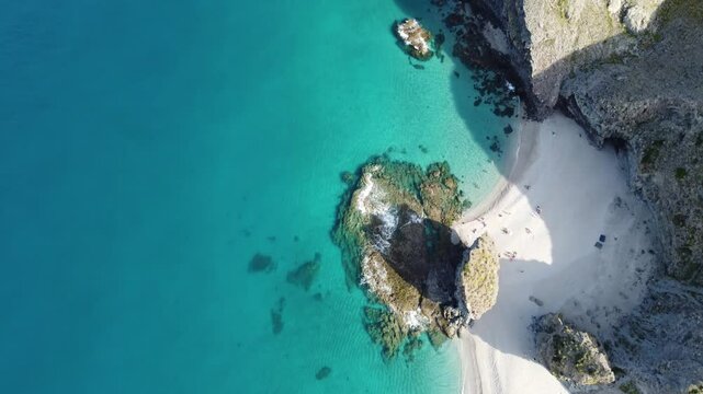 Drone footage of the Playa de Los Muertos. Drone looking down at the horse shoe shaped cove at the far end of this stunningly beautiful beach, with half the frame showing white sand and aqua blue sea