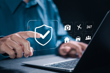 Insurance concept. Businessman using laptop with insurance icons on virtual screen for medical health, life and travel insurance, service Insurance online cyber security privacy