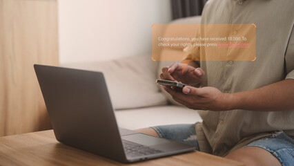 Male user holding a mobile phone and viewing messages on mobile phone. Fake Text message SMS scam or phishing concept.