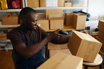 African American worker scanning barcode on order before shipment