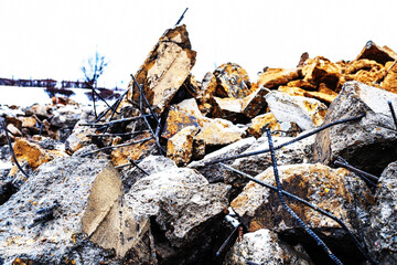 Large concrete blocks with protruding metal fittings disposed of after the dismantling of the building. Close-up. Selective focus