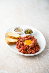 Traditional steak tartare with egg yolk