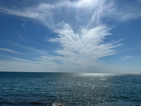 Blue ocean glittering beautiful water and amazing sky clouds