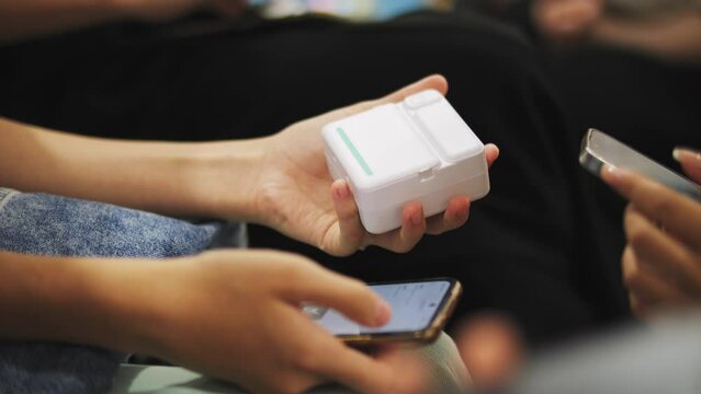 A child prints a photo on a mini printer