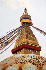 Boudhanath stupa in Kathmandu, Nepal decorated Buddha wisdom eyes and prayer flags, most popular tourist attractions in Kathmandu reflecting harmonious blend of spirituality and tourism