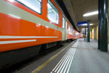 Obraz premium Railroad Station and a Train at night in Lugano, Ticino, Switzerland.