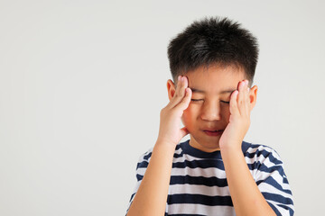 Portrait of Asian young kid boy sad tired strain face holding hold head by hands, stress primary child person unhappy closed eyes problem headache, studio shot isolated on white background