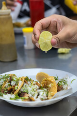 Close-Up of Delicious Tacos Being Garnished with Fresh Lime Juice