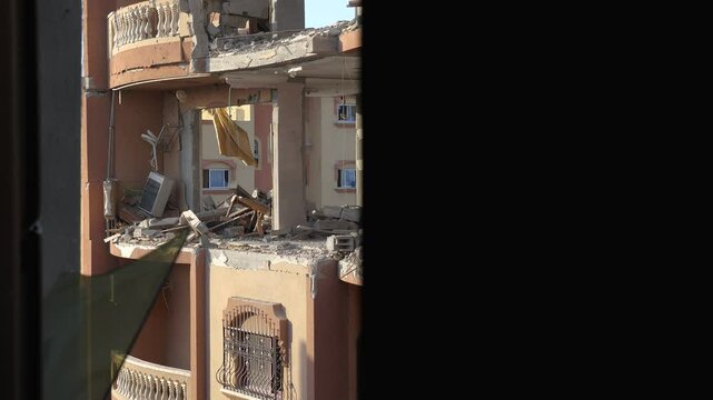 Camera reveals Palestinians residential buildings damaged after Israeli bombardment of the Gaza Strip neighbourhood 
