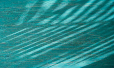 Summer tropical background with blurred palm leaves. Wood background with shadows from palm leaf
