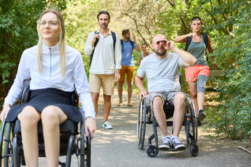 People with mobility disabilities enjoying a day at the park with friends