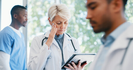 Fototapeta premium Senior woman, doctor and headache in burnout, grief or mistake with digital report in hospital building. Frustrated physician, medical healthcare and person in stress, loss or fatigue at clinic
