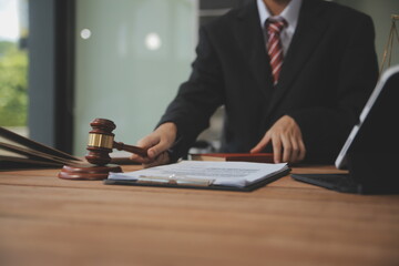 Judge gavel with Justice lawyers having team meeting at law firm background. Concepts of Law and...
