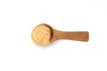 heap of maca powder in a wooden spoon isolated on white background