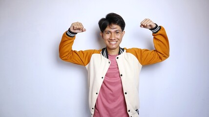Casual excited young handsome Asian man wearing jacket, strong gesture, enthusiastic