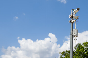 Surveillance Cameras on Pole with Blue Sky