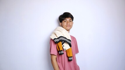 casual smiling young handsome asian man carrying jacket