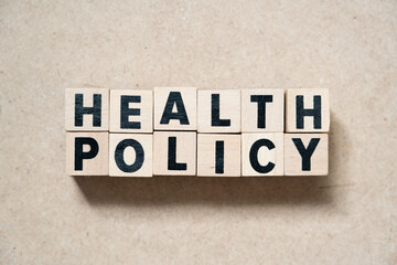 Alphabet letter block in word health policy on wood background
