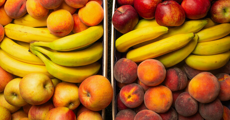 many colorful fresh juicy peaches, apples, bananas for banner background.vitamins diet nutrition summer fruits concept