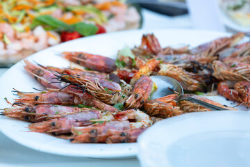 grilled prawns served on a white plate for wedding reception buffet