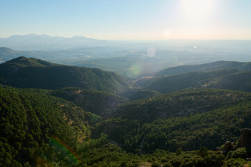 Scenic view of mountain range and valleys under clear blue sky