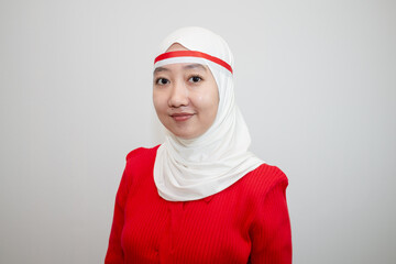 Woman in white hijab wearing red sweater. celebrating Indonesia's independence day. facing side. isolation on white background.