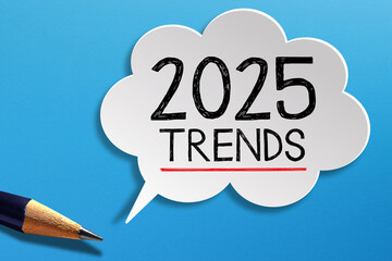 2025 Trends written on speech bubble with pencil on blue background