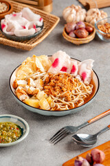 Emie, mie rebus is a noodle soup made from broth shrimp, topping boiled egg and potato, dried shrimp, fried onion and onion leaf.