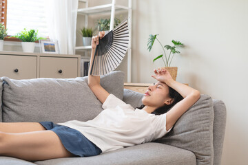Suffering summer heat wave stroke, hot weather, tired asian young woman feeling discomfort sweaty,...