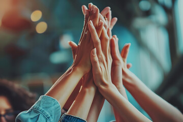 diverse group of people giving high five, symbolizing teamwork and collaboration Background features modern, cozy interior with warm lighting, emphasizing spirit of unity and celebration among group
