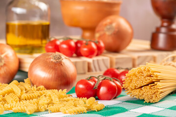 Pasta, table with pasta, ingredients and utensils, selective focus.