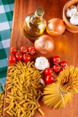 Pasta, table with pasta, ingredients and utensils, top view.