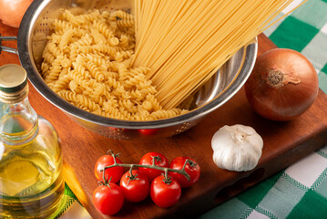 Pasta, table with pasta, ingredients and utensils, selective focus.