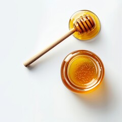 Honey jar with wooden honey dipper on white background top view with copy space. Delicious honey bottle.