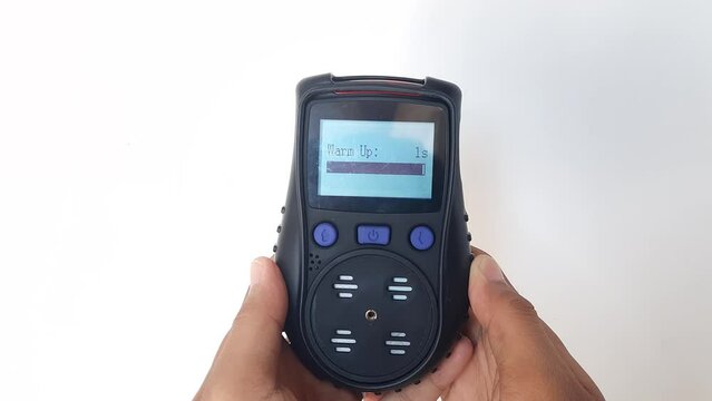 Using a portable gas detector to monitor the composition of the surrounding air or toxic gases (on a white background). Industrial action.