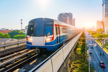 Electric train motion blur effect railway carriage rushes turn travels along route in sunset sky...