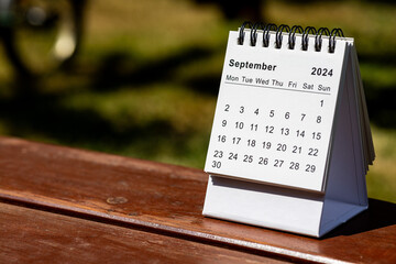 September 2024 paper calendar - month page on the wooden table
