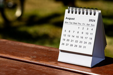 August 2024 paper calendar - month page on the wooden table